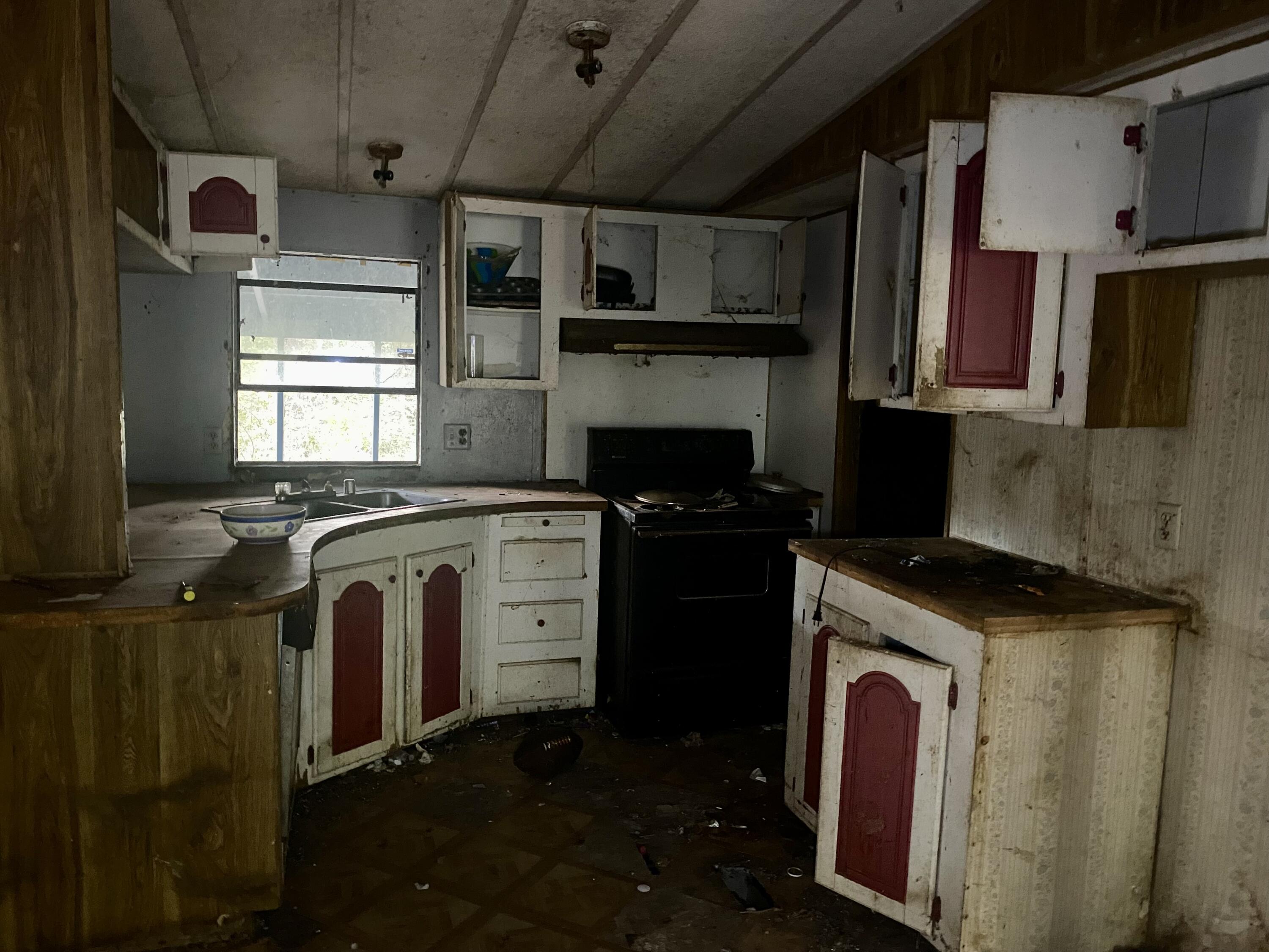 4977 Douglas Ferry Road Caryville, FL 32427 - Photo 7 of 16 a kitchen with a stove and a refrigerator