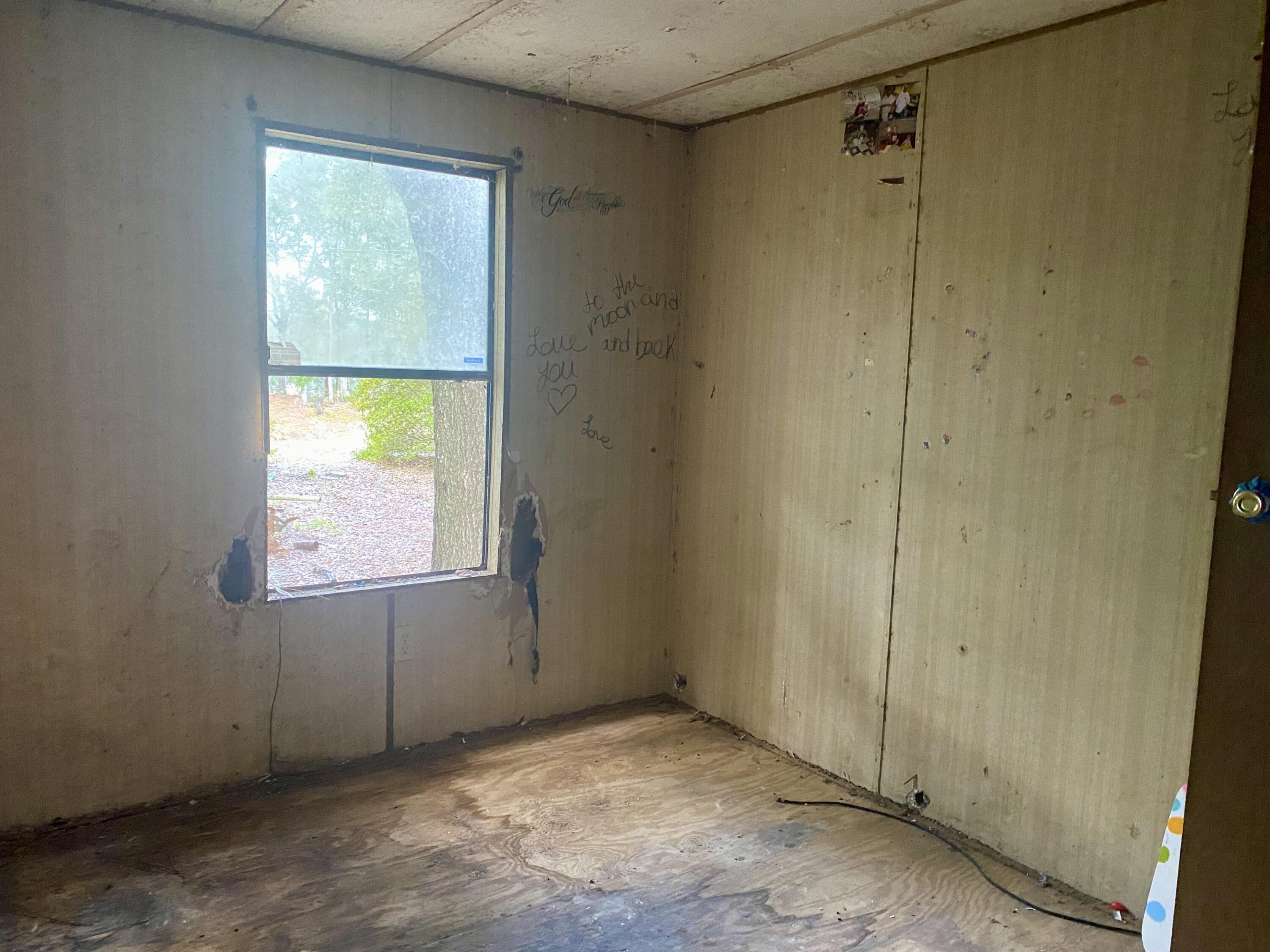 4977 Douglas Ferry Road Caryville, FL 32427 - Photo 8 of 11 a view of an empty room with a window