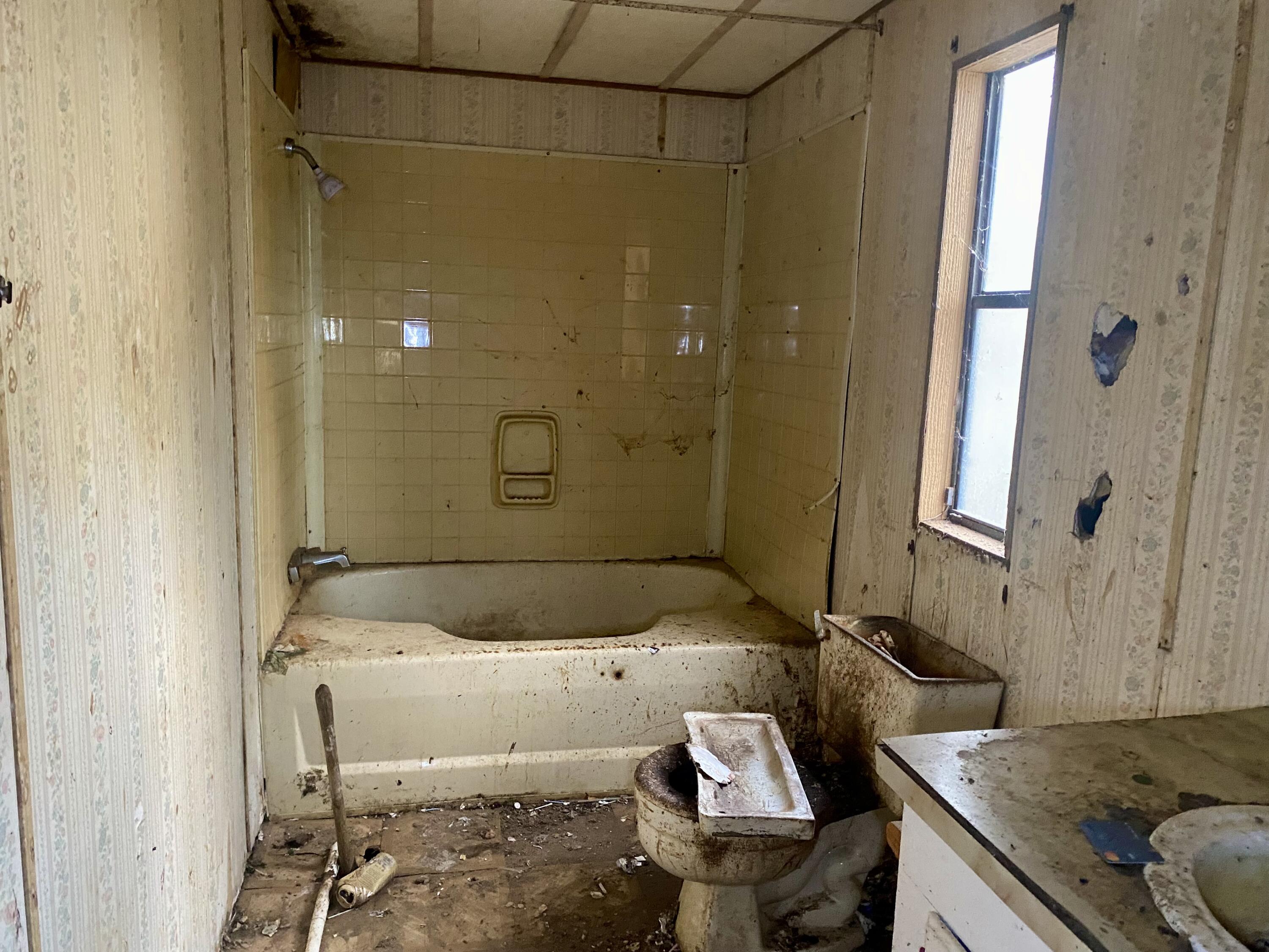 4977 Douglas Ferry Road Caryville, FL 32427 - Photo 10 of 11 a bathroom with a granite countertop sink and a mirror
