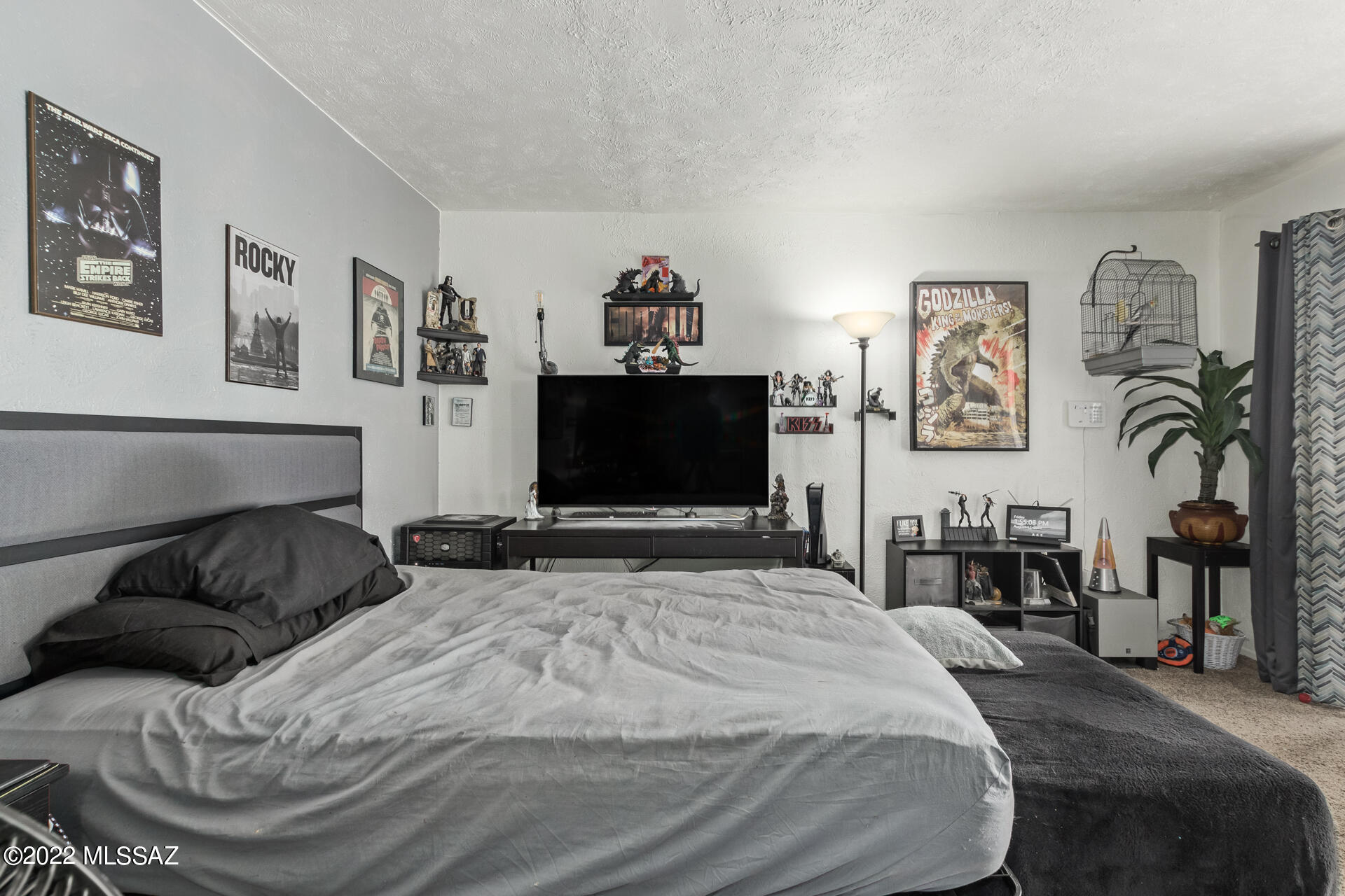 1620 North Wilmot Road, Unit D273 Tucson, AZ 85712 - Photo 5 of 15 a bedroom with a bed and a flat screen tv