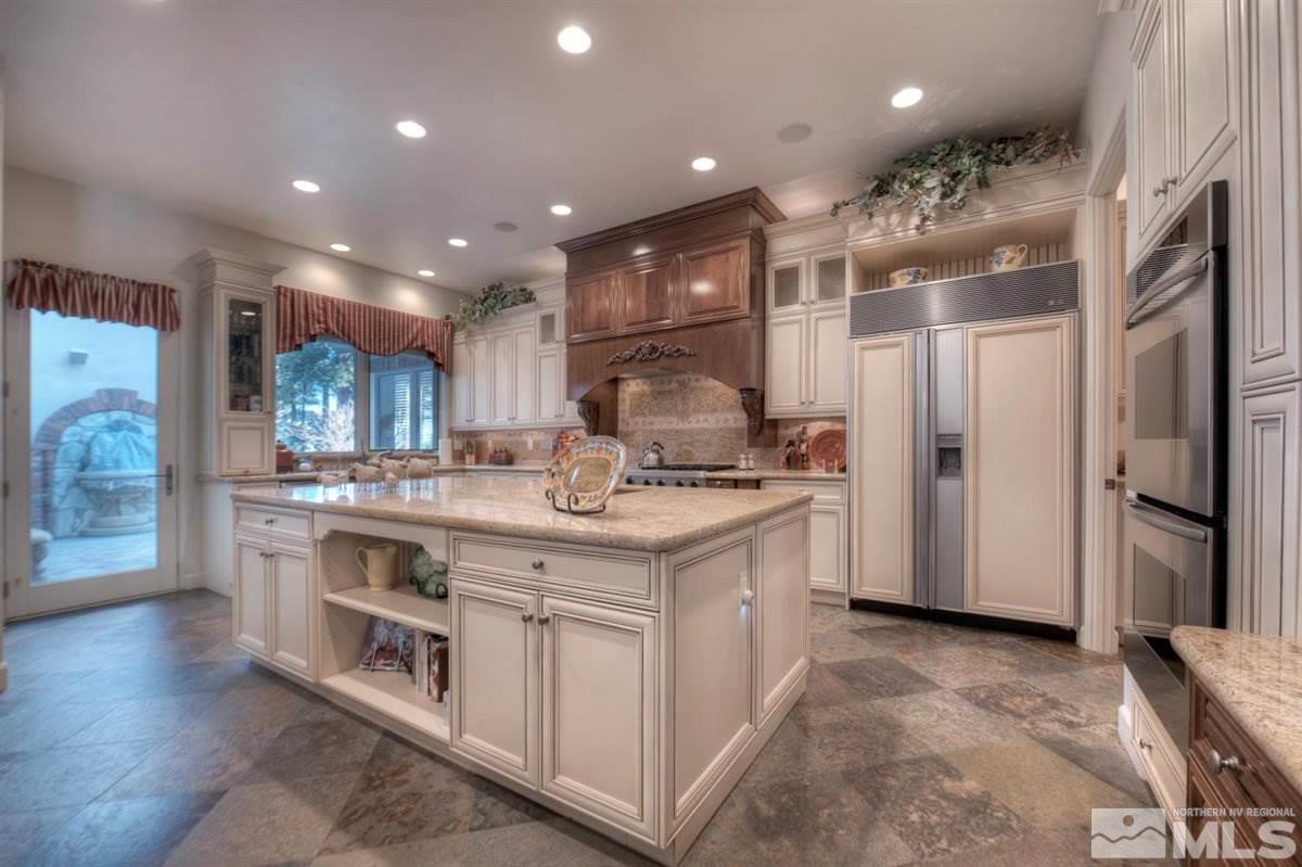 5915 Chambery Circle Reno, NV 89511 - Photo 18 of 40 a kitchen with stainless steel appliances granite countertop a sink and a refrigerator
