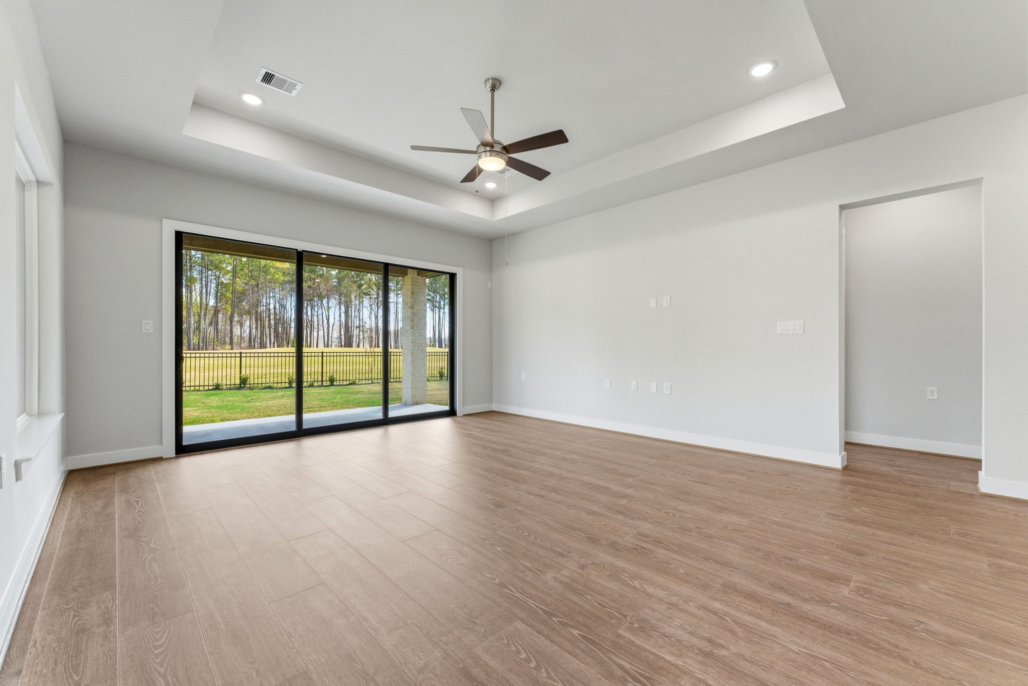 21807 Victory Green Way Porter, TX 77365 - Photo 11 of 50 an empty room with wooden floor and windows