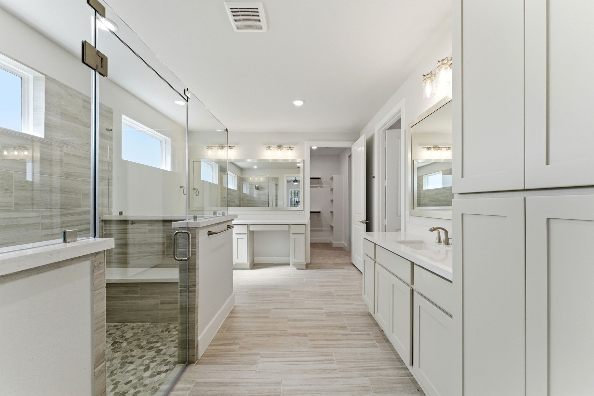 21807 Victory Green Way Porter, TX 77365 - Photo 15 of 50 a large white kitchen with lots of counter space wooden floor and stainless steel appliances
