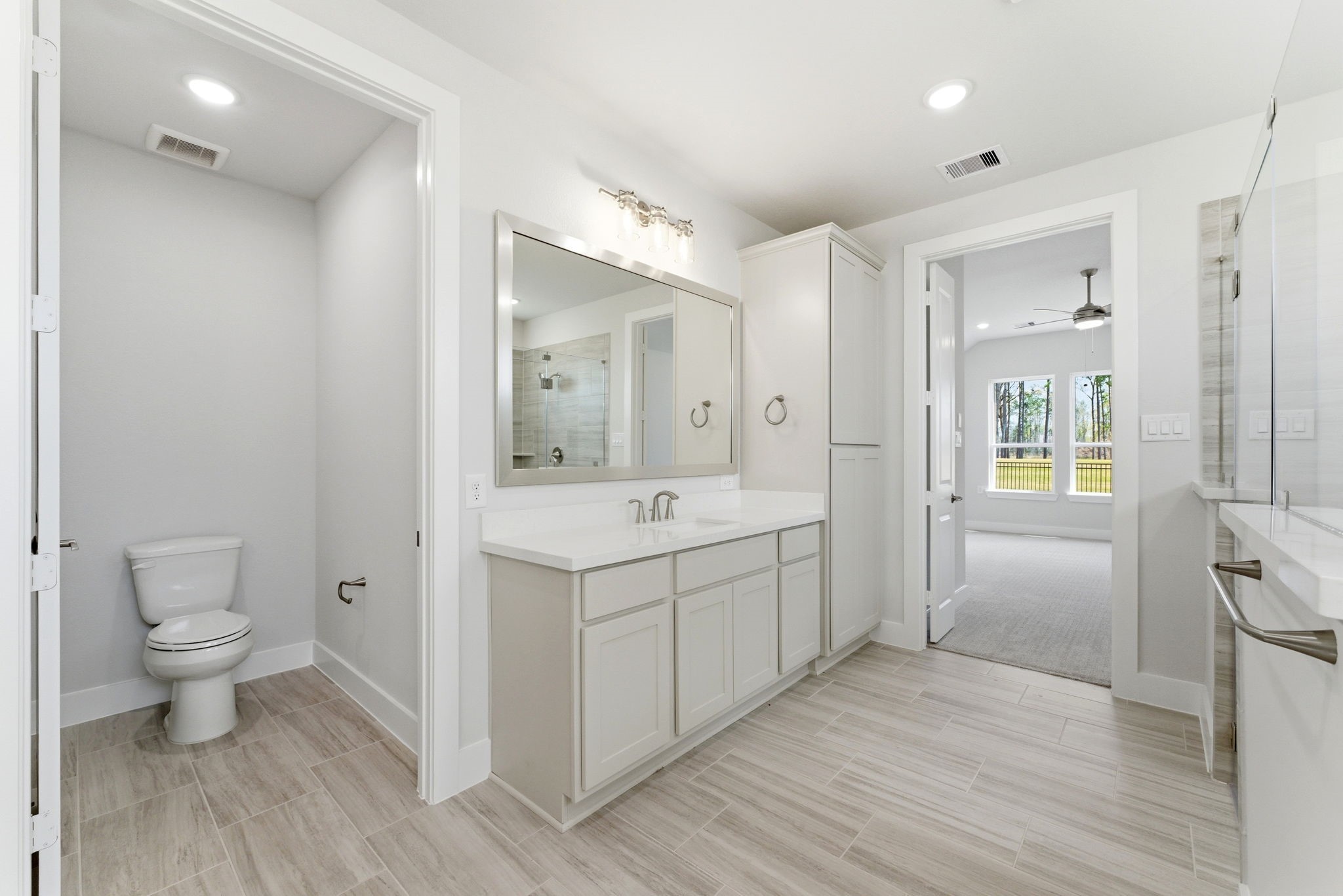 21807 Victory Green Way Porter, TX 77365 - Photo 17 of 50 a bathroom with a sink a toilet and shower