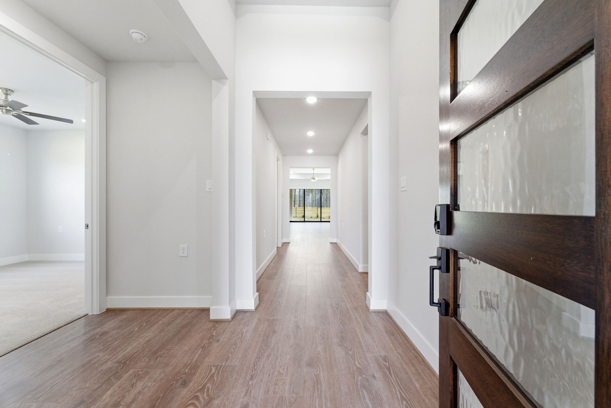 21807 Victory Green Way Porter, TX 77365 - Photo 2 of 50 a view of a hallway with wooden floor and staircase
