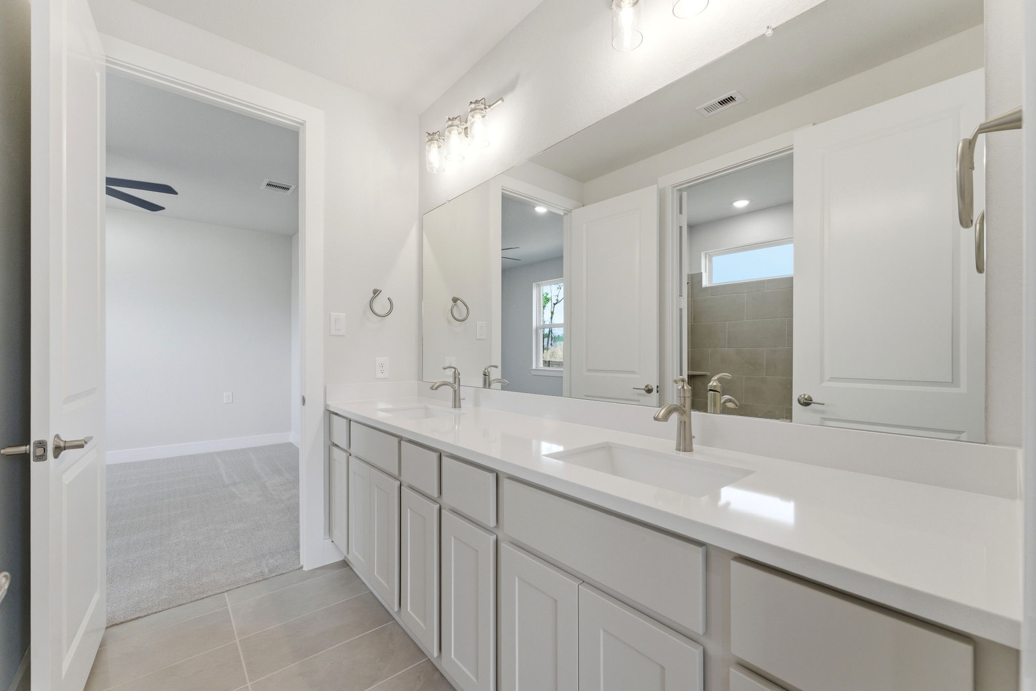 21807 Victory Green Way Porter, TX 77365 - Photo 21 of 50 a bathroom with a double vanity sink mirror and double