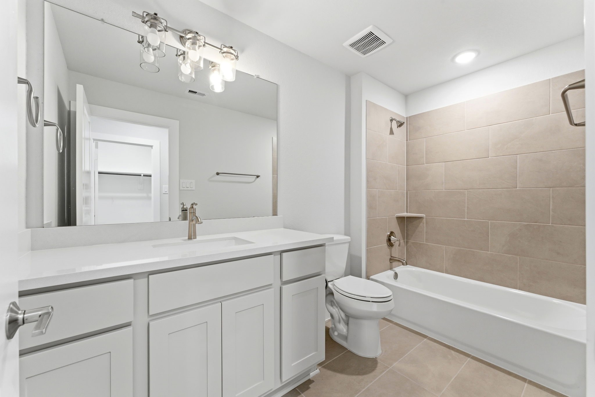 21807 Victory Green Way Porter, TX 77365 - Photo 28 of 50 a bathroom with a sink a toilet and a large mirror