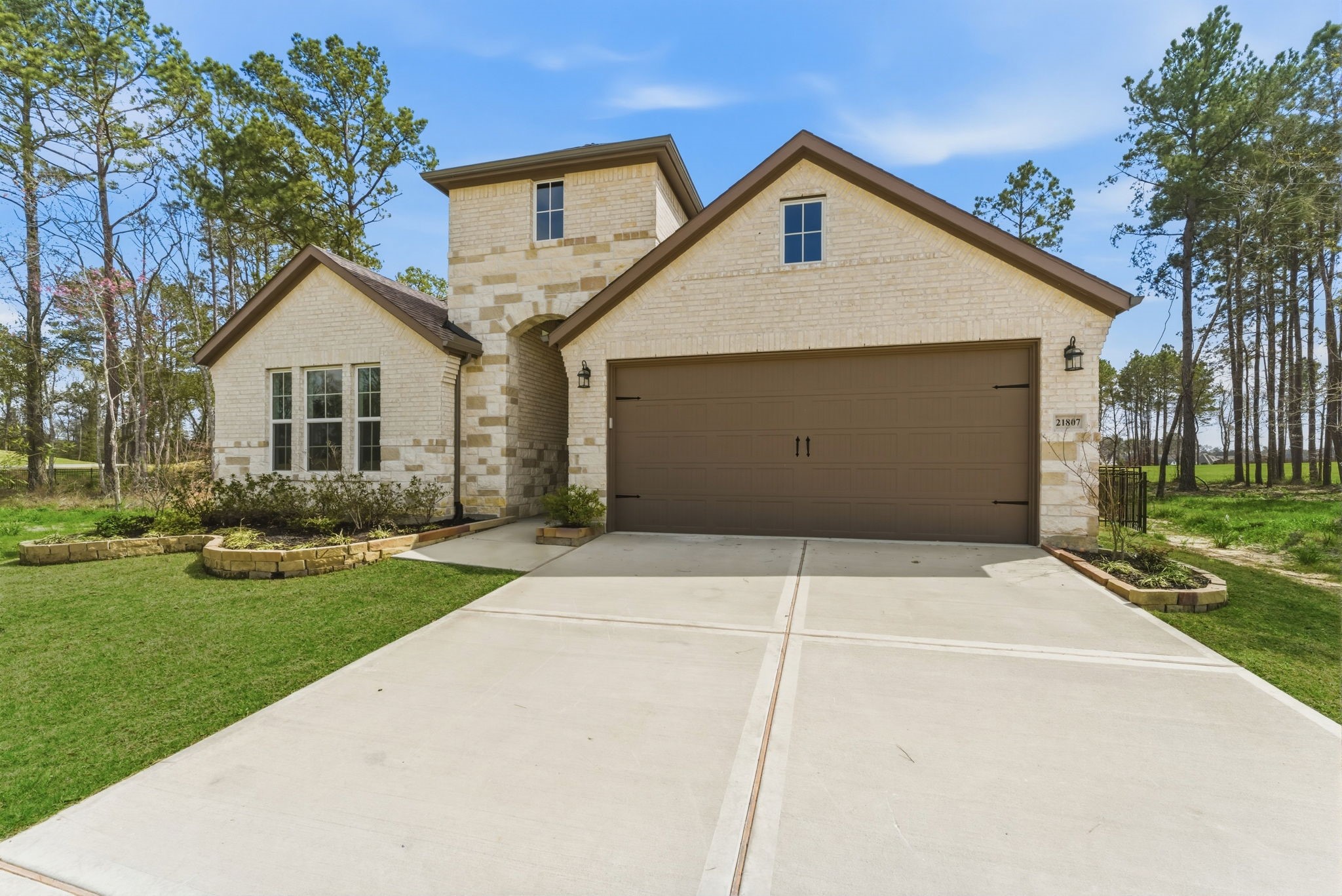 21807 Victory Green Way Porter, TX 77365 - Photo 42 of 50 a front view of a house with a yard and garage
