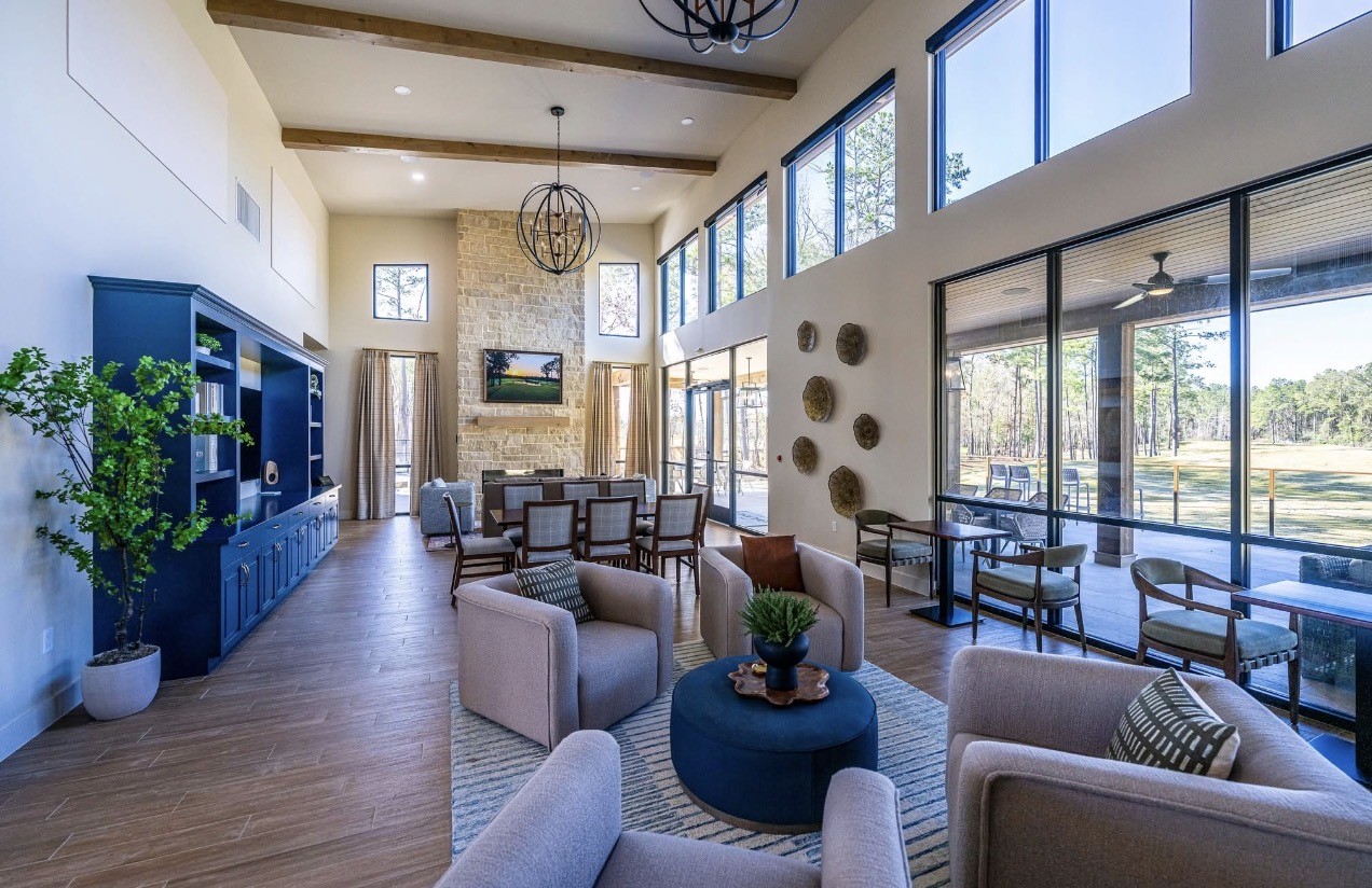 21807 Victory Green Way Porter, TX 77365 - Photo 45 of 50 a living room with furniture potted plant floor to ceiling windows and wooden floor