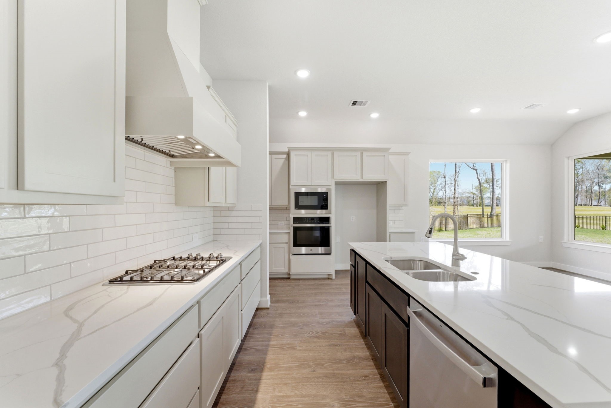 21807 Victory Green Way Porter, TX 77365 - Photo 5 of 50 a large kitchen with a large counter top a sink stainless steel appliances and cabinets