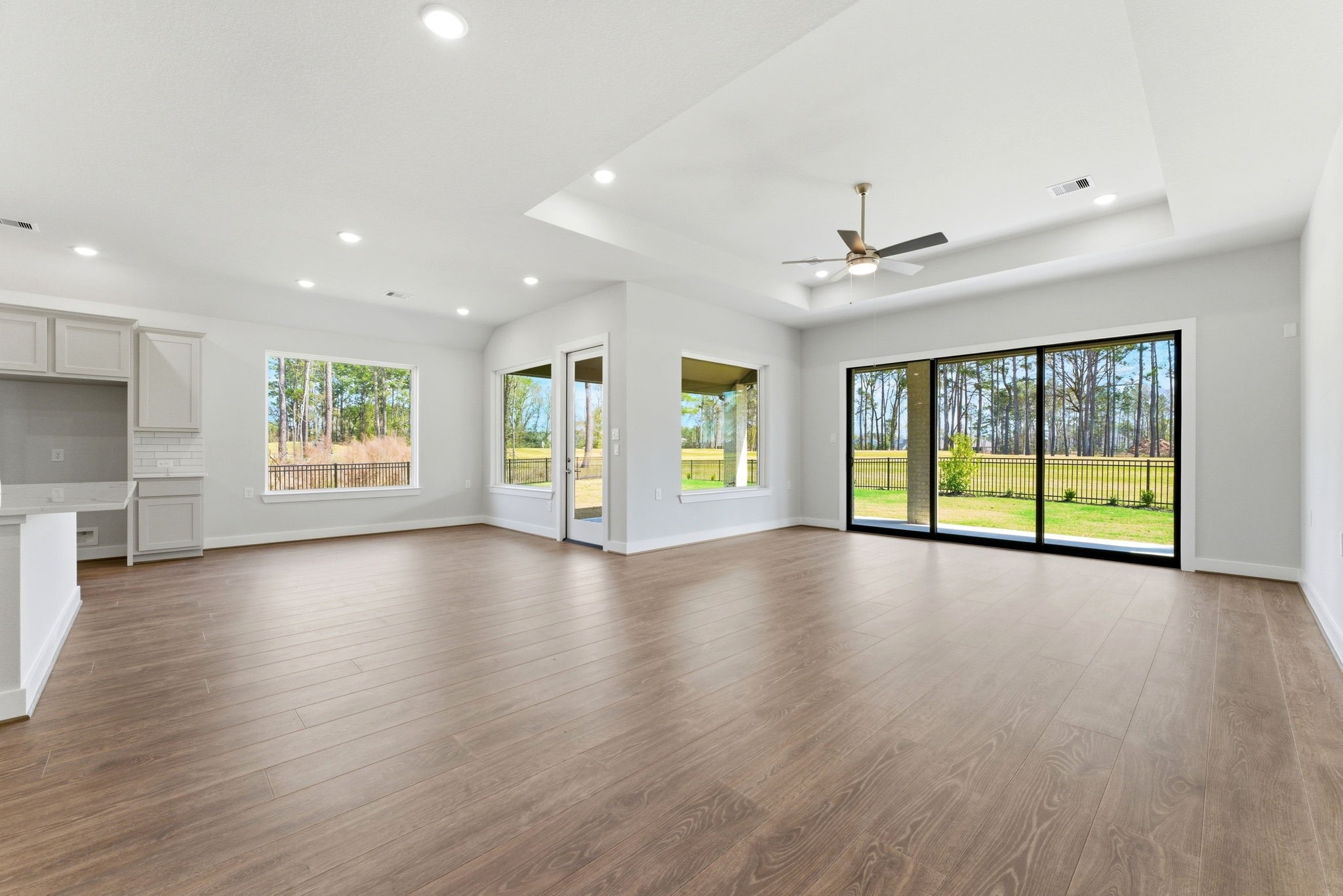 21807 Victory Green Way Porter, TX 77365 - Photo 9 of 50 a view of an empty room with a window and wooden floor