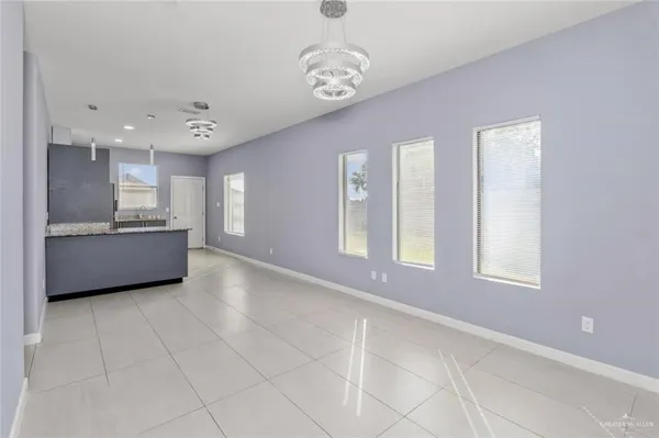 a view of an empty room with window and cabinet