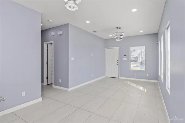 an empty room with fan and windows