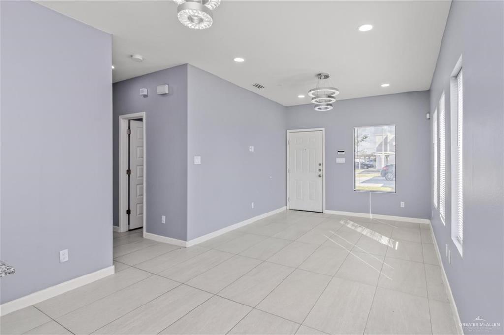 1200 West Harrison Avenue, Unit 2 Alton, TX 78573 - Photo 5 of 11 an empty room with fan and windows