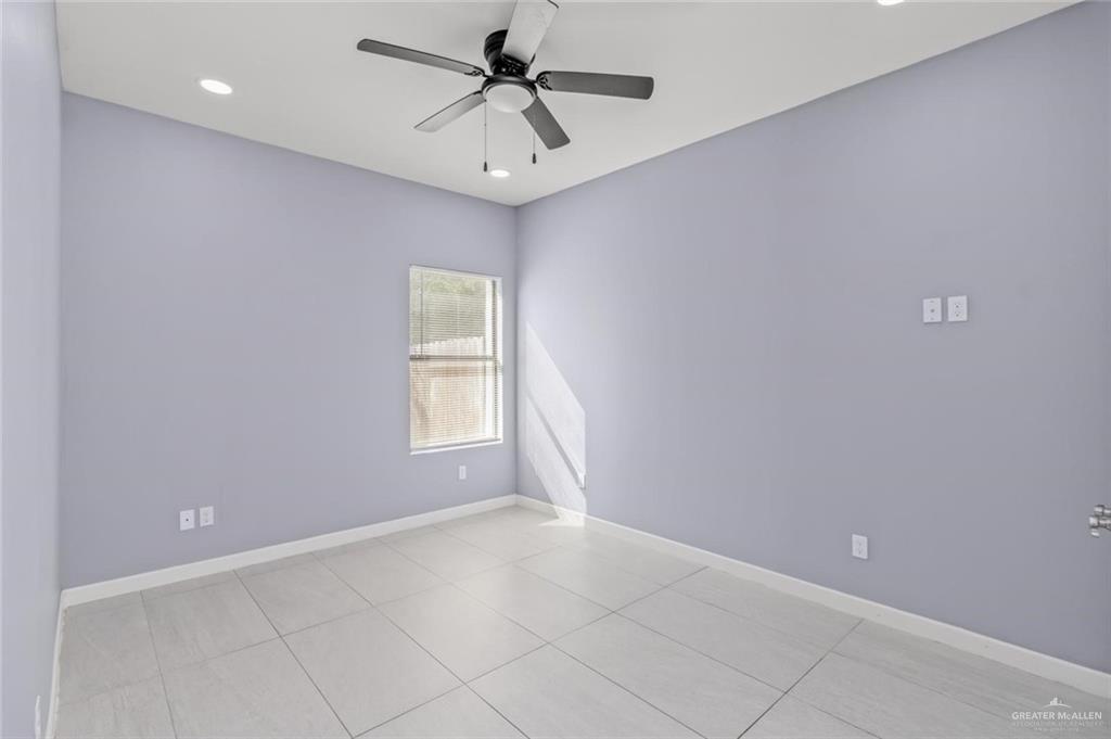 1200 West Harrison Avenue, Unit 2 Alton, TX 78573 - Photo 7 of 11 an empty room with a ceiling fan and window