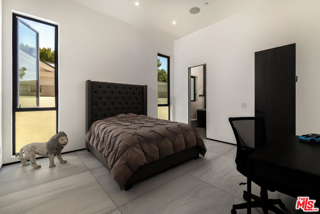 621 North Rodeo Drive Beverly Hills, CA 90210 - Photo 12 of 28 a bedroom with a bed tv and a dresser
