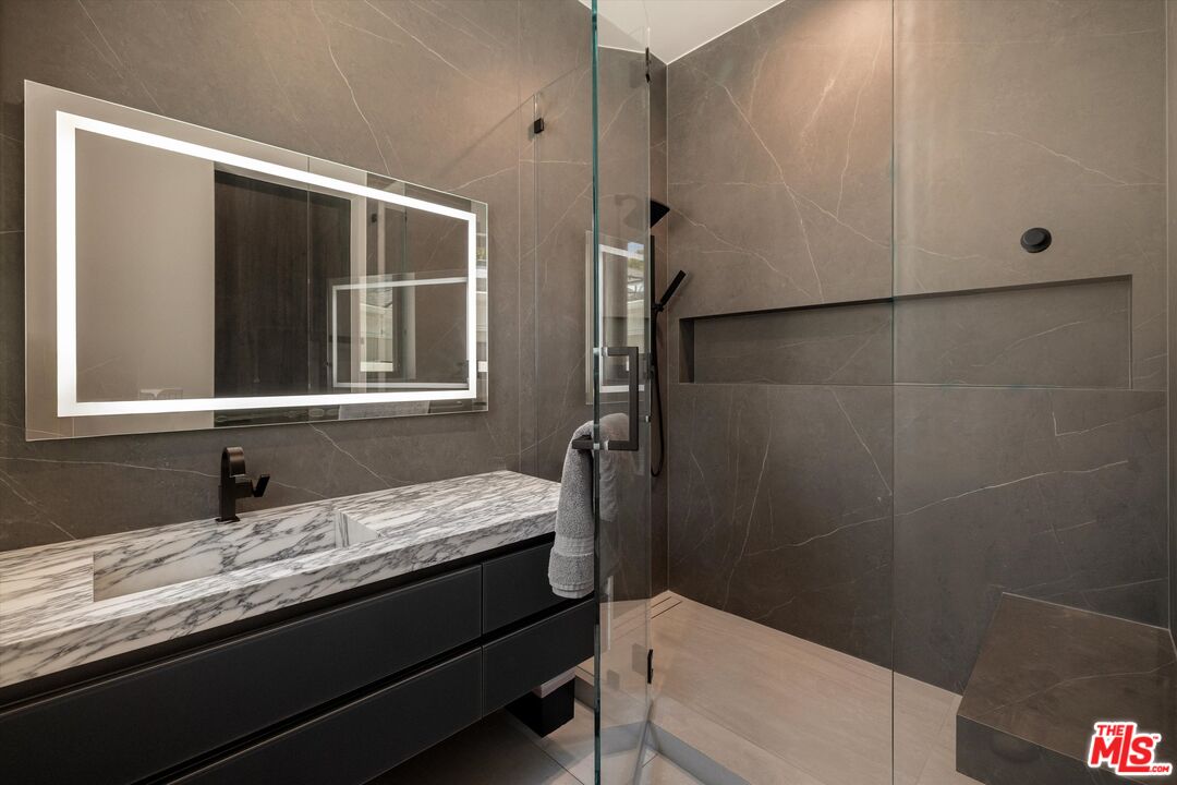 621 North Rodeo Drive Beverly Hills, CA 90210 - Photo 13 of 28 a bathroom with a granite countertop sink toilet and shower