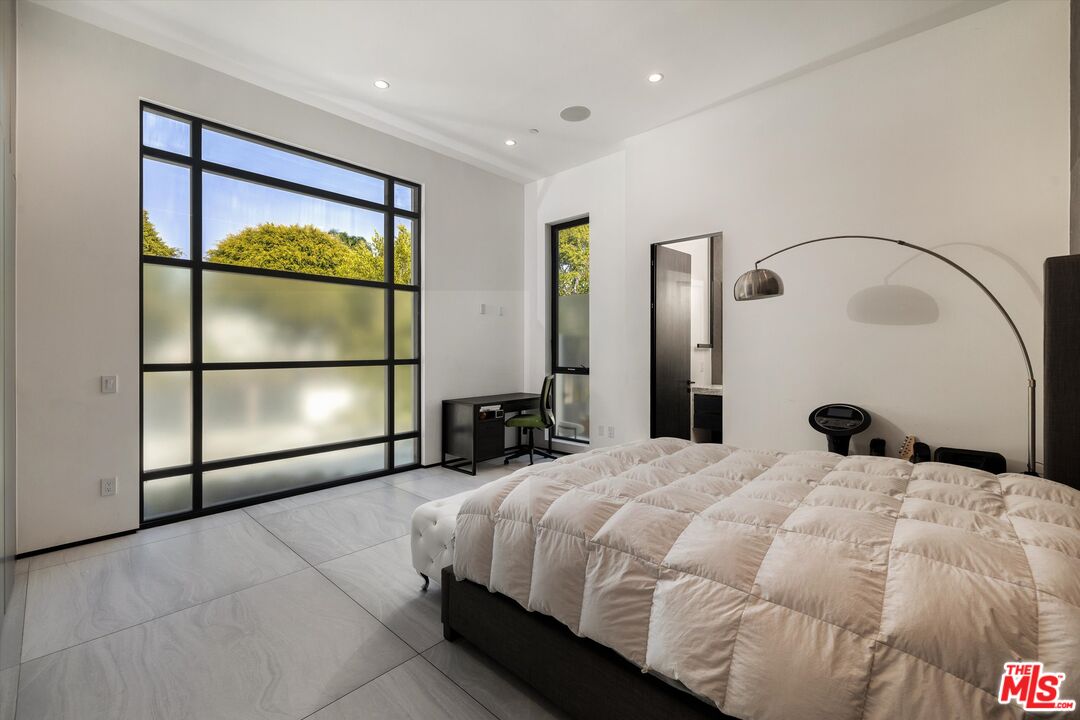 621 North Rodeo Drive Beverly Hills, CA 90210 - Photo 14 of 28 a bedroom with a bed and a painting on the wall