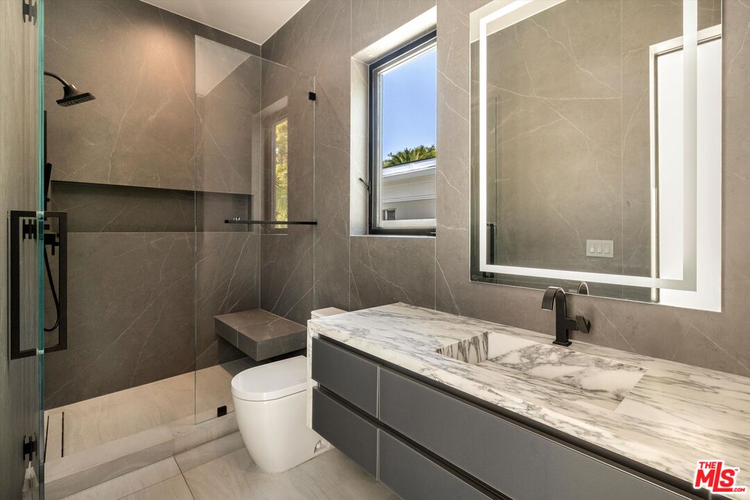 621 North Rodeo Drive Beverly Hills, CA 90210 - Photo 17 of 28 a bathroom with a granite countertop sink toilet and shower
