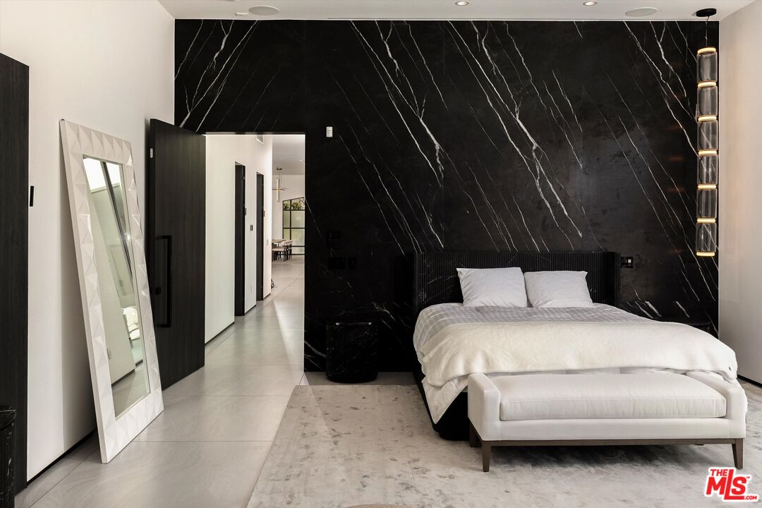 621 North Rodeo Drive Beverly Hills, CA 90210 - Photo 20 of 28 a bedroom with a bed and a black gate