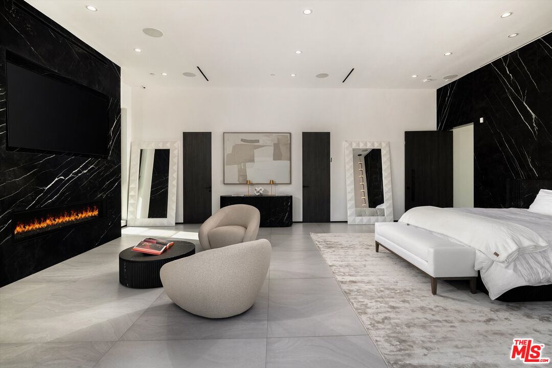 621 North Rodeo Drive Beverly Hills, CA 90210 - Photo 22 of 28 a living room with furniture and a flat screen tv