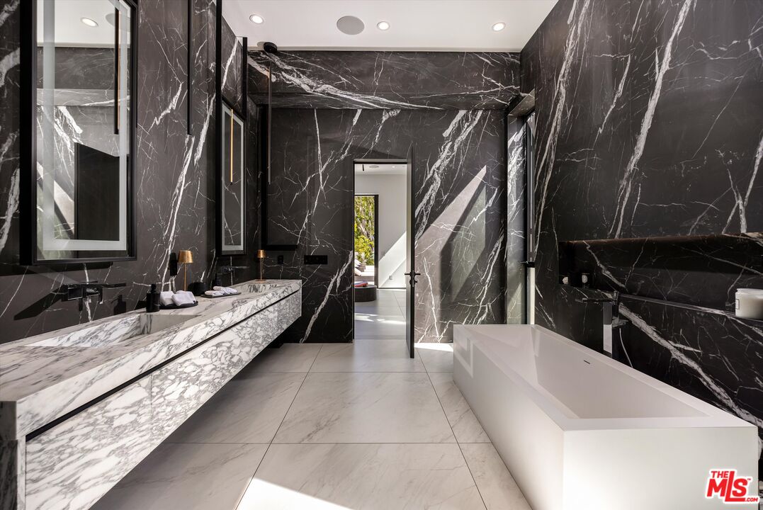621 North Rodeo Drive Beverly Hills, CA 90210 - Photo 23 of 28 a bathroom with a bathtub and a sink