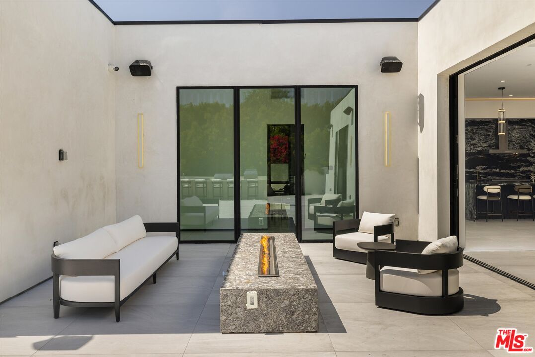 621 North Rodeo Drive Beverly Hills, CA 90210 - Photo 25 of 28 a living room with furniture and a large window