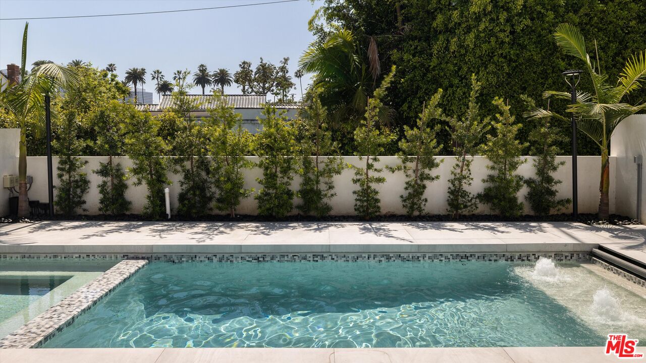 621 North Rodeo Drive Beverly Hills, CA 90210 - Photo 27 of 28 a view of a yard with wooden fence