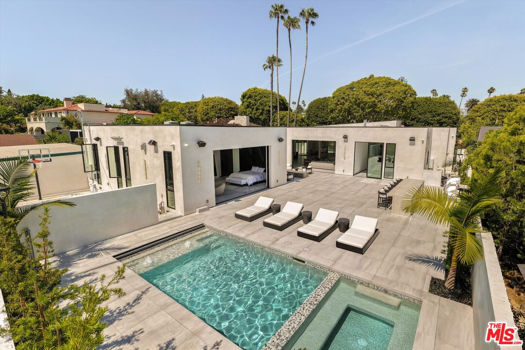 621 North Rodeo Drive Beverly Hills, CA 90210 - Photo 28 of 28 a view of a house with backyard outdoor seating area and furniture