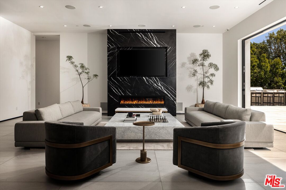 621 North Rodeo Drive Beverly Hills, CA 90210 - Photo 4 of 28 a living room with furniture and a flat screen tv