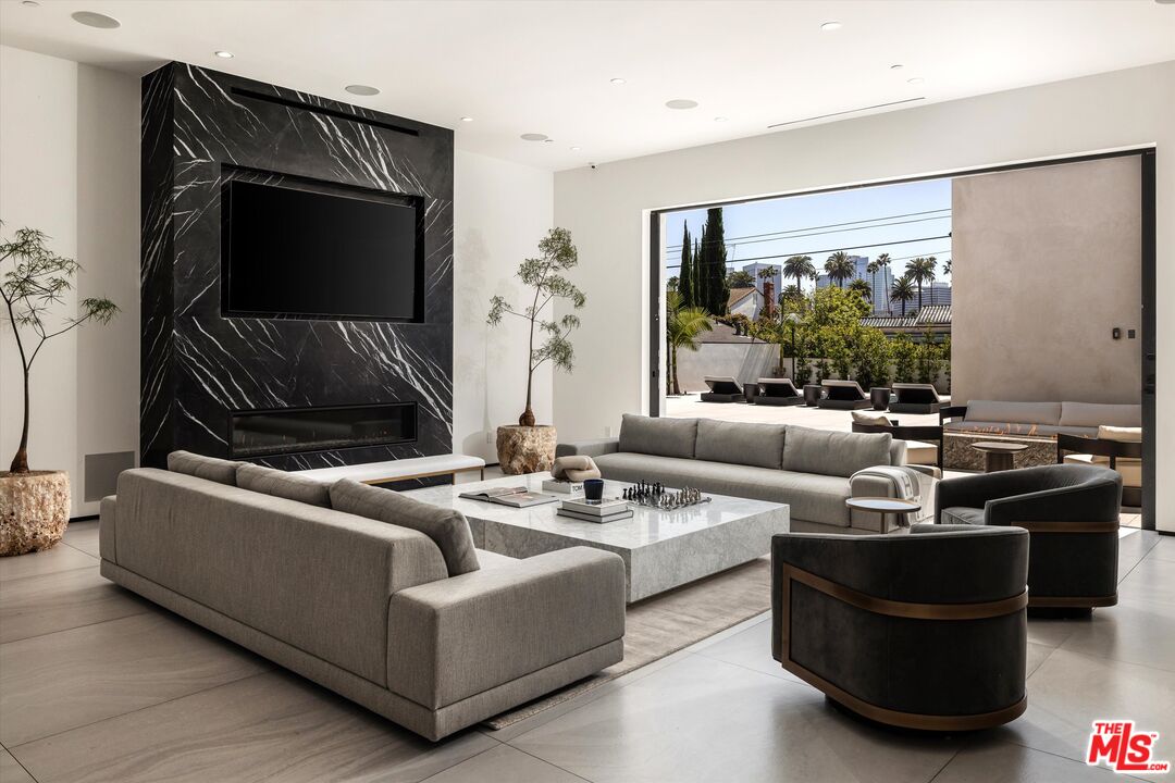 621 North Rodeo Drive Beverly Hills, CA 90210 - Photo 5 of 28 a living room with furniture and a flat screen tv