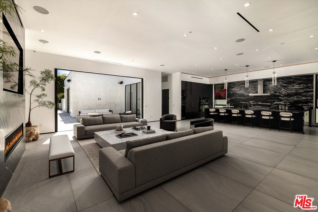 621 North Rodeo Drive Beverly Hills, CA 90210 - Photo 6 of 28 a living room with furniture and a flat screen tv