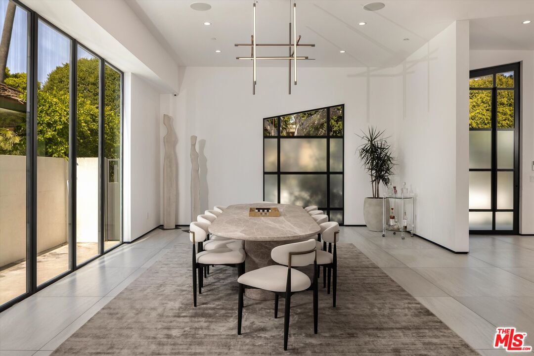 621 North Rodeo Drive Beverly Hills, CA 90210 - Photo 8 of 28 a view of a dining room with furniture window and wooden floor