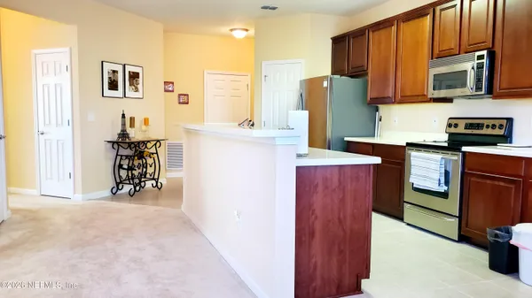 a kitchen with stainless steel appliances granite countertop a refrigerator and a stove