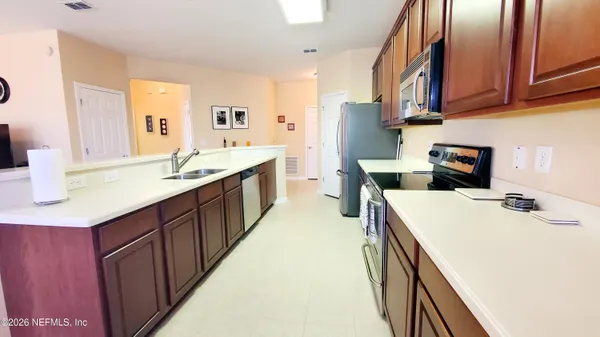 a kitchen with stainless steel appliances granite countertop a refrigerator and a sink