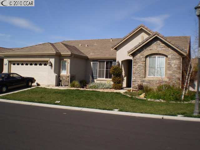 3447 Keystone Loop Discovery Bay, CA 94505 - Photo 1 of 1 a front view of a house with a yard and garage