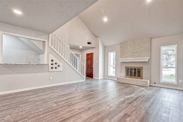 a view of a livingroom with wooden floor and fireplace
