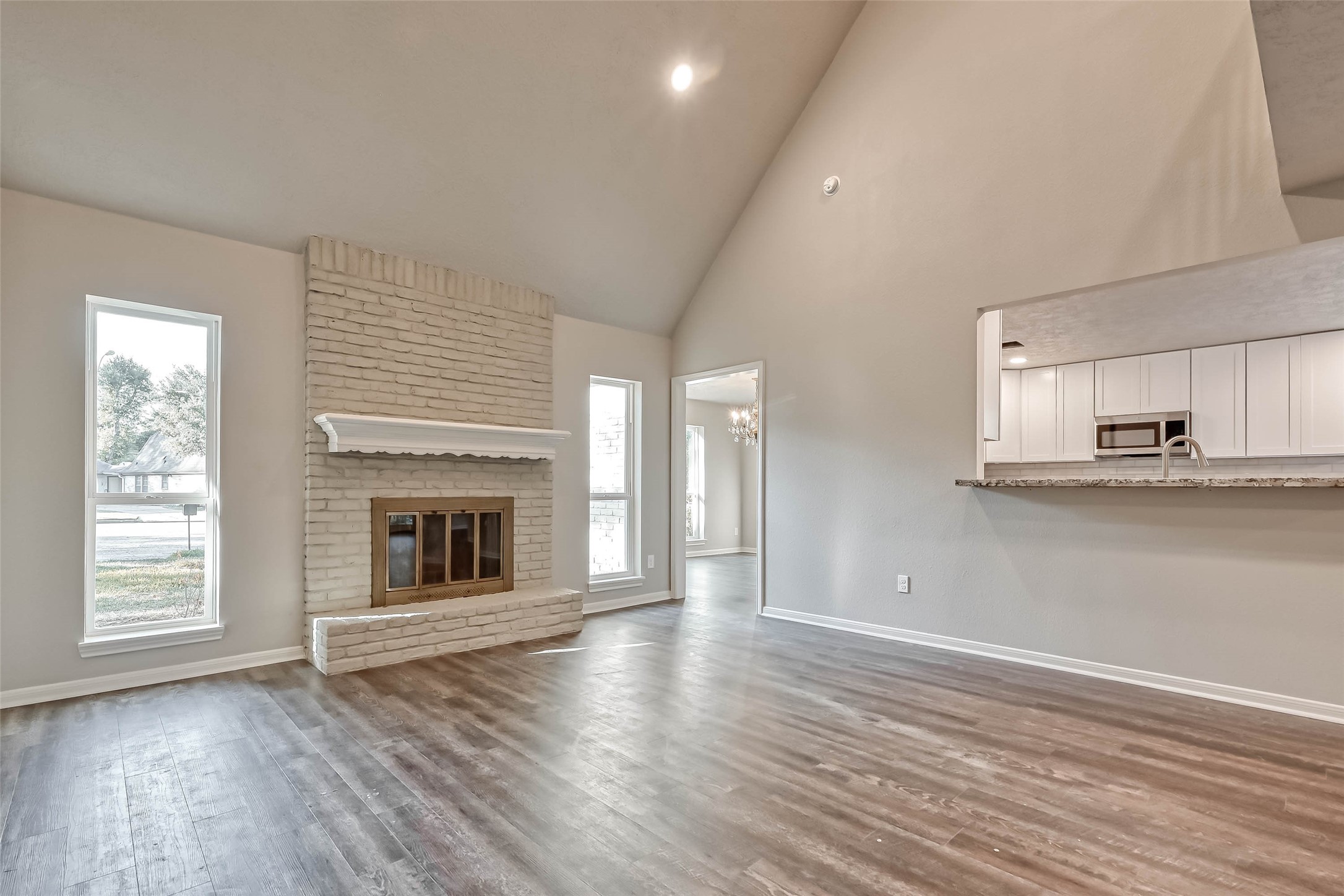 3615 Highfalls Drive Houston, TX 77068 - Photo 16 of 45 an empty room with wooden floor fireplace and windows
