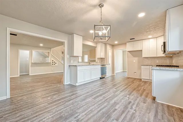 a view of a kitchen with wooden floor and a sink