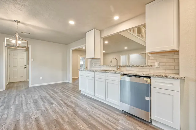 a large kitchen with kitchen island a sink stainless steel appliances and cabinets