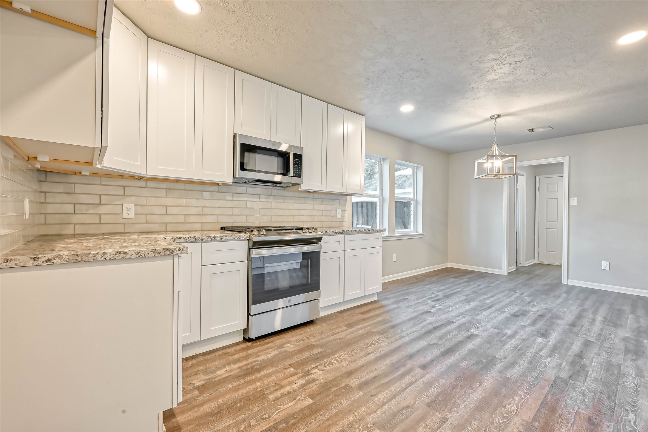 3615 Highfalls Drive Houston, TX 77068 - Photo 24 of 45 a kitchen with stainless steel appliances granite countertop a stove a sink and a microwave