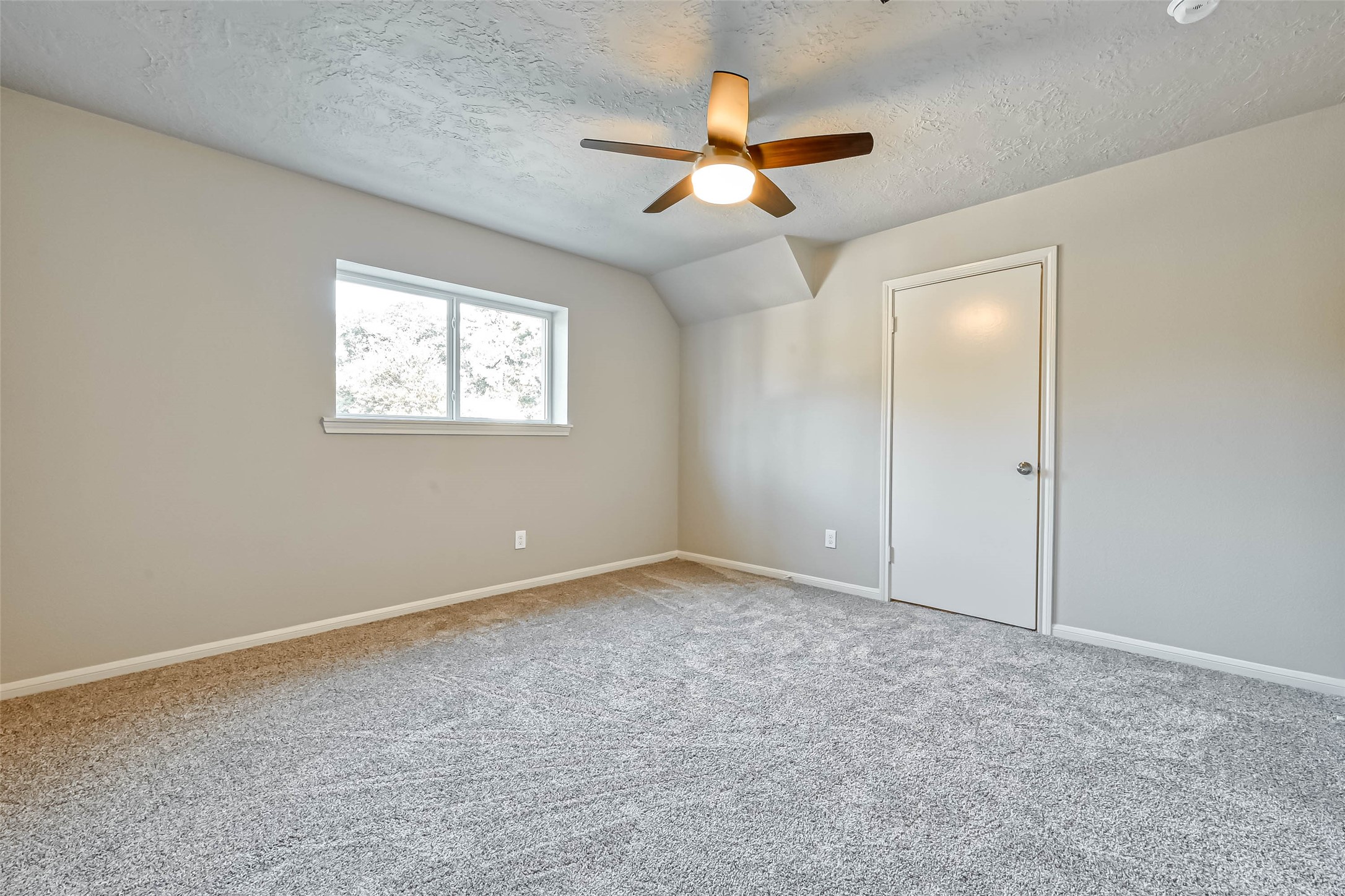 3615 Highfalls Drive Houston, TX 77068 - Photo 28 of 45 an empty room with windows and fan