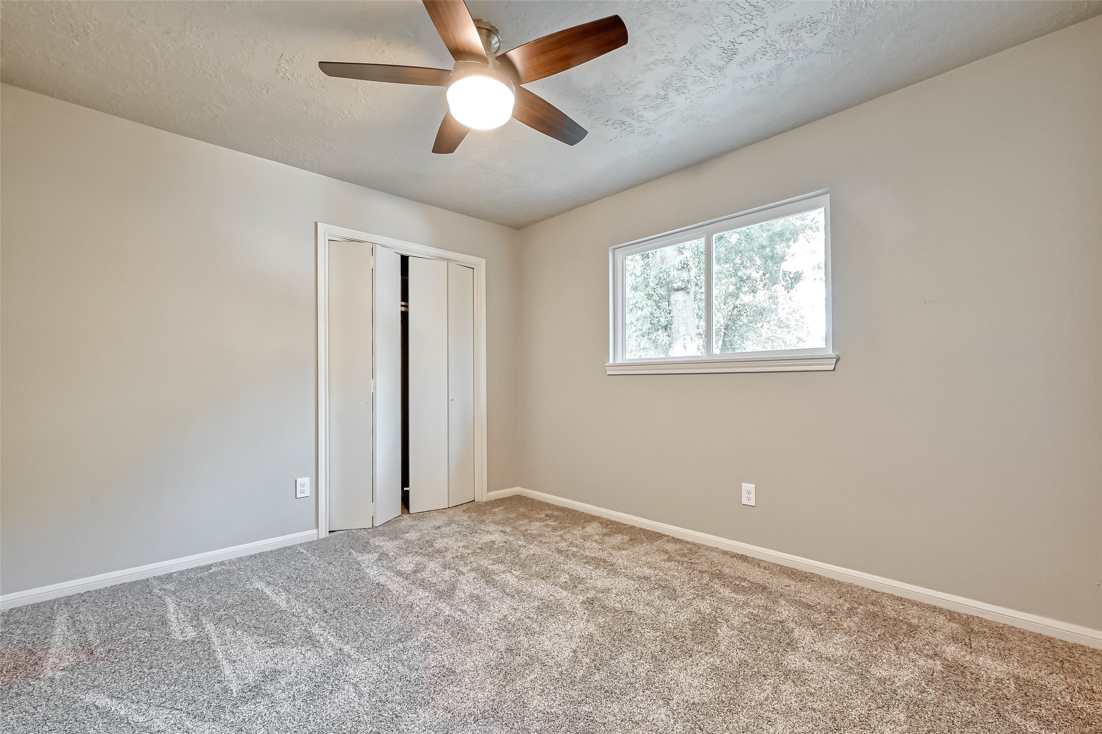 3615 Highfalls Drive Houston, TX 77068 - Photo 29 of 45 an empty room with windows and fan