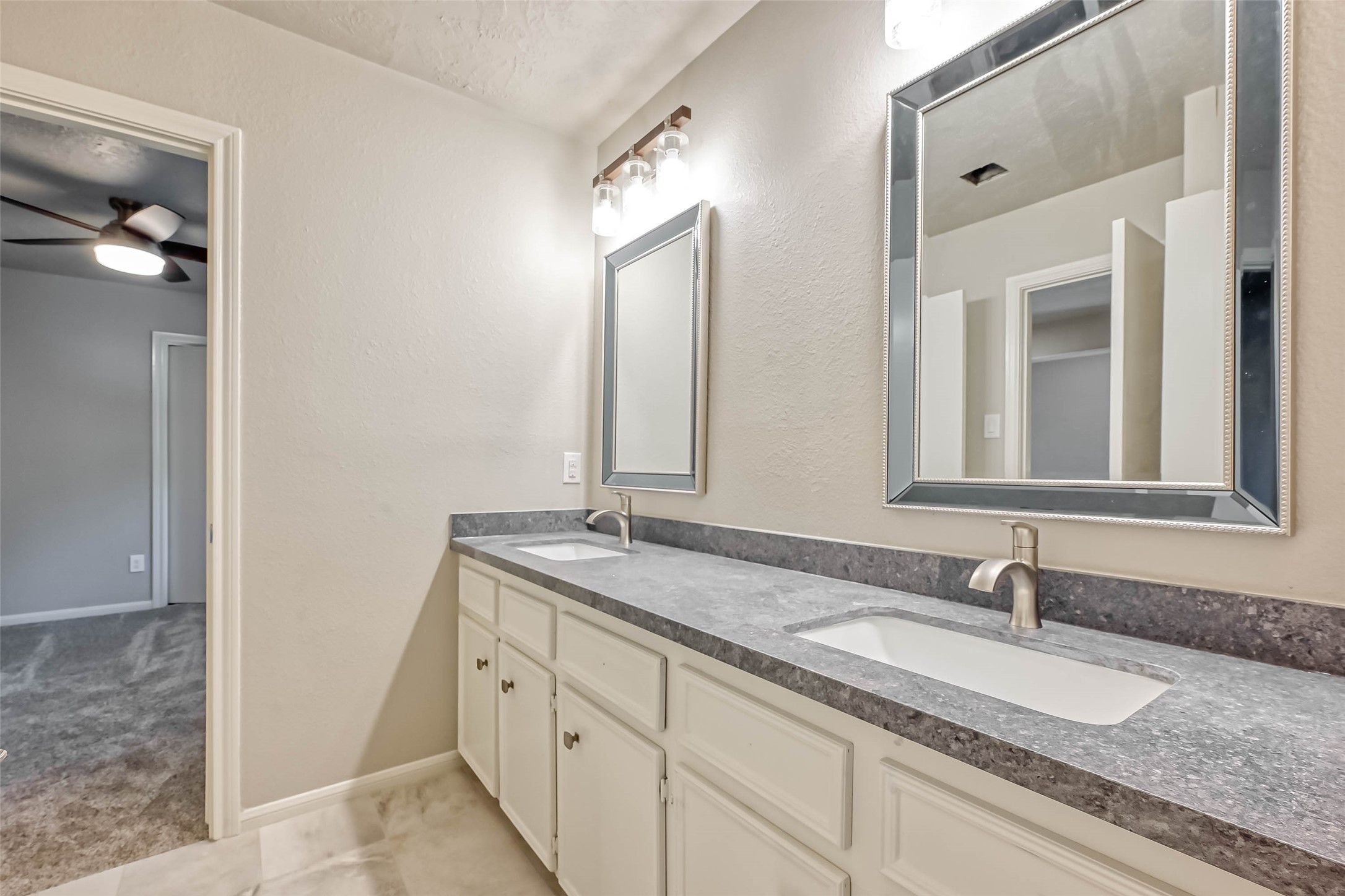 3615 Highfalls Drive Houston, TX 77068 - Photo 31 of 45 a bathroom with a granite countertop double vanity sink and a mirror