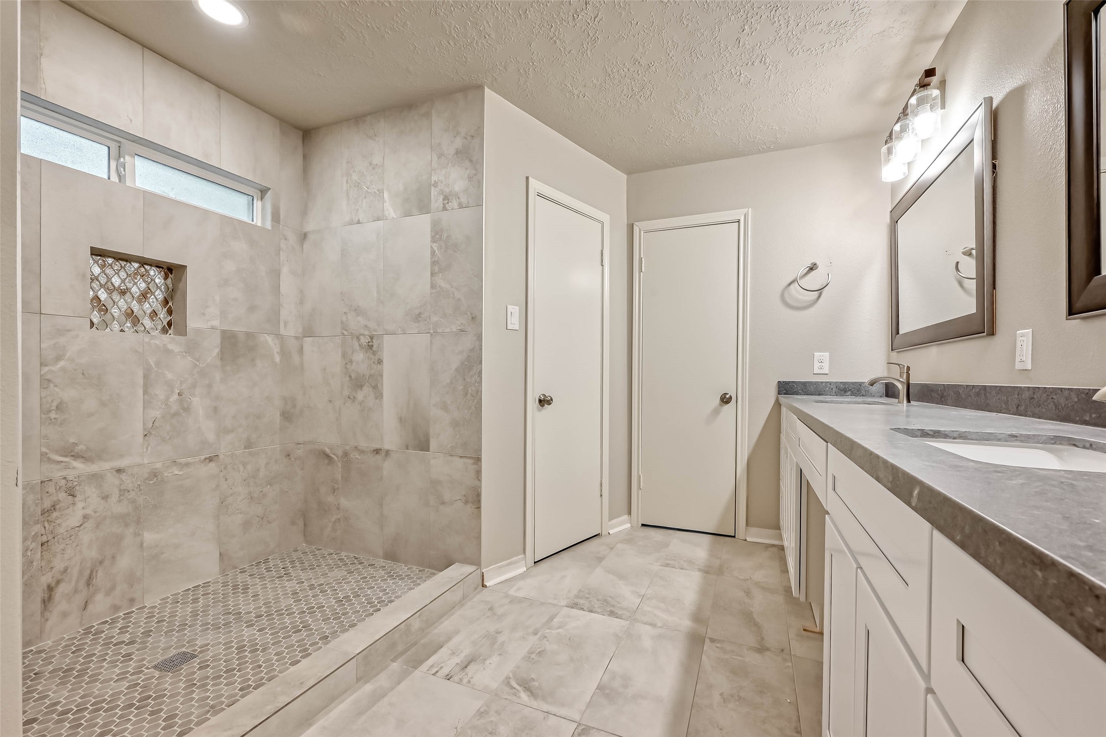 3615 Highfalls Drive Houston, TX 77068 - Photo 39 of 45 a bathroom with a granite countertop sink a mirror and shower