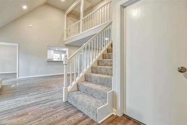 a view of entryway and hall with wooden floor