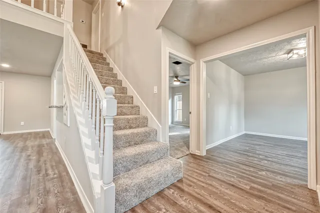 a view of entryway and hall with wooden floor