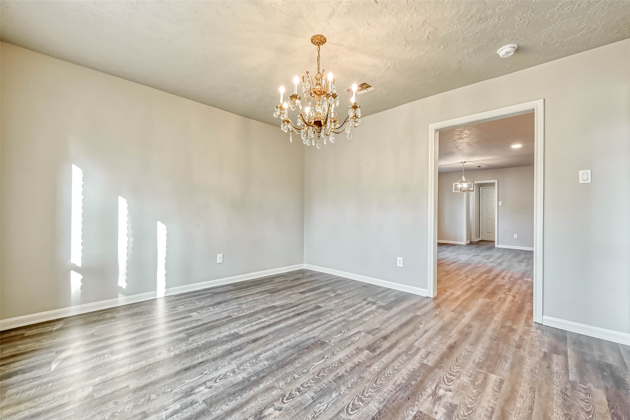 3615 Highfalls Drive Houston, TX 77068 - Photo 9 of 45 a view of a chandelier in big room with wooden floor