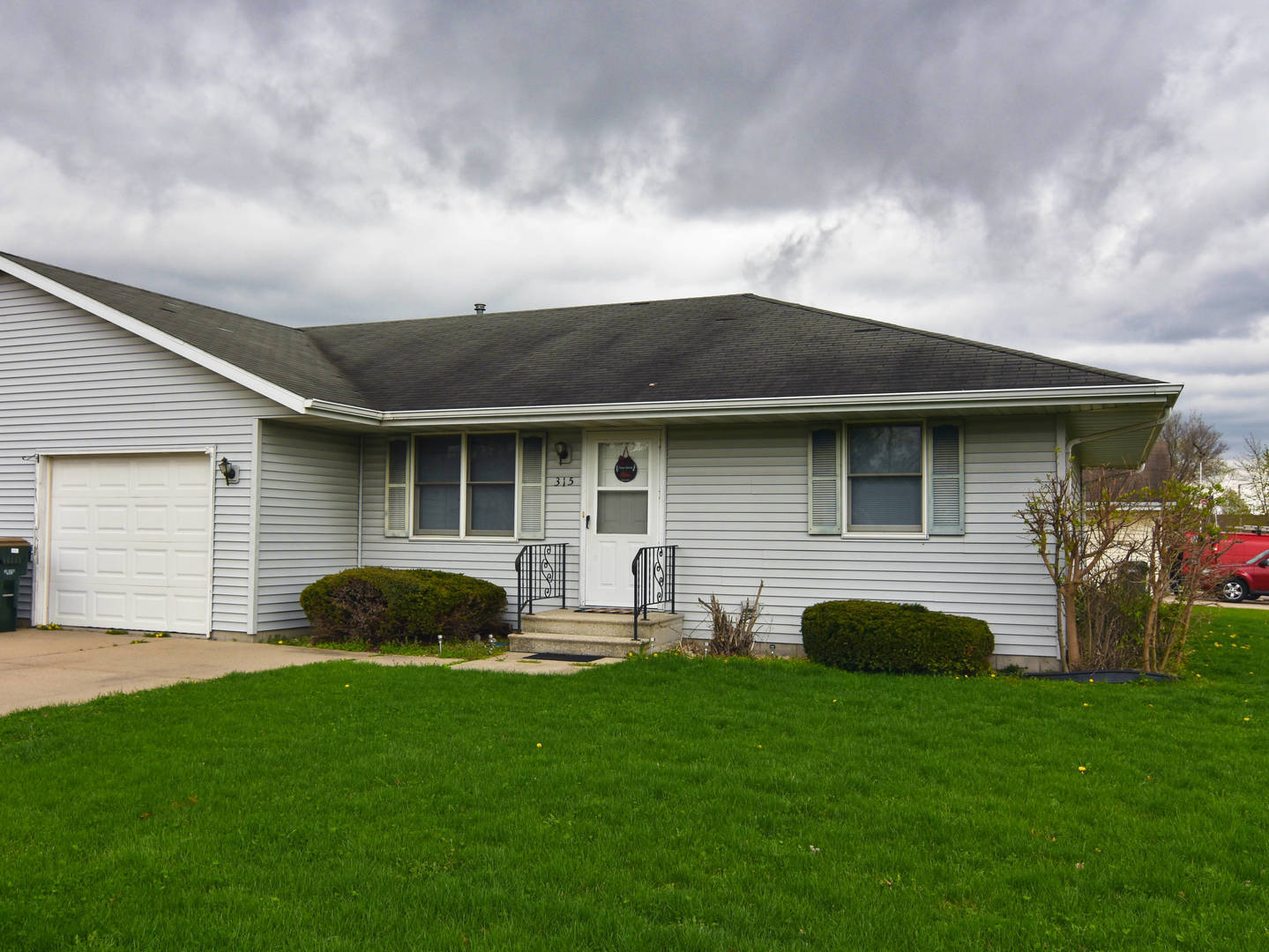 a backyard of a house with table and chairs