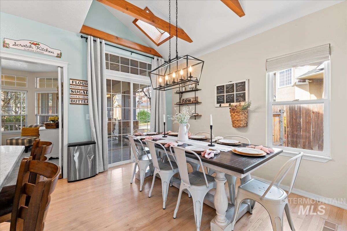 6326 North Talcrest Place Boise, ID 83713 - Photo 12 of 34 Dining room featuring vaulted ceiling, light wood-type flooring, and suspended lighting
